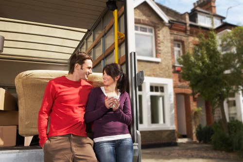 Professional movers handling furniture in a Pimlico apartment building